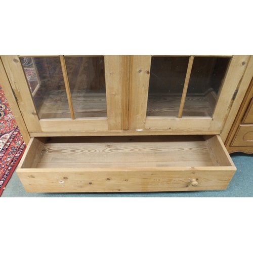 143 - A 20th century pine two door glazed display cabinet, 199cm high x 127cm wide x 56cm deep