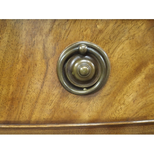 24 - A 20th century mahogany bow front sideboard with central drawer over tambour doors flanked by cabine... 