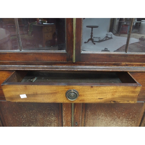 26 - A 19th century mahogany glazed corner cabinet with moulded cornice over pair of glazed doors over si... 