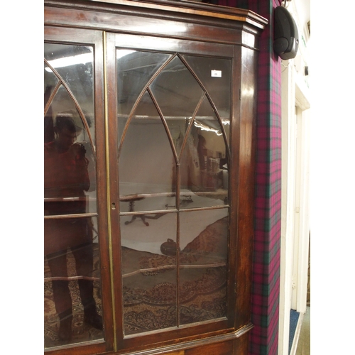 26 - A 19th century mahogany glazed corner cabinet with moulded cornice over pair of glazed doors over si... 