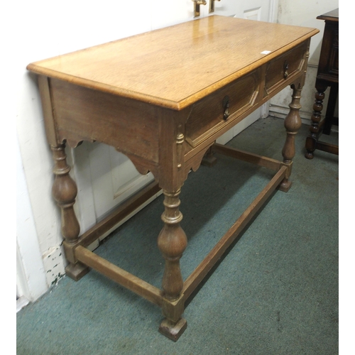 28 - A 20th century honeyed oak two drawer hall table on stretchered turned supports, 78cm high x 104cm w... 