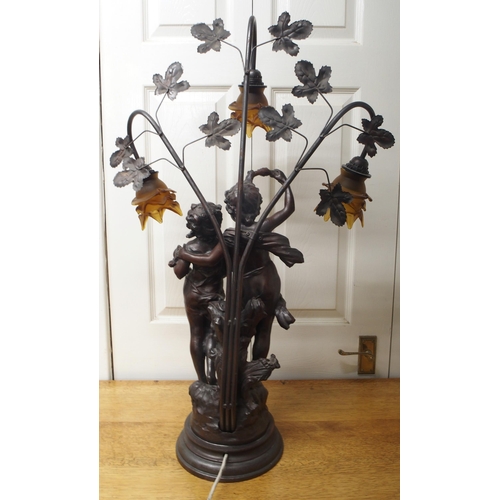 30 - A 20th century spelter figural table lamp with three floral moulded glass shades, 84cm high