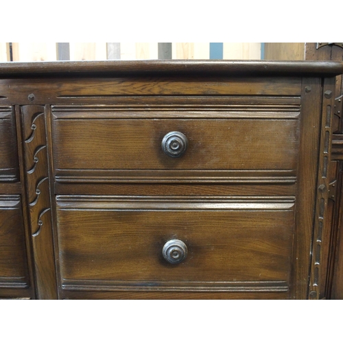 62 - A mid 20th century elm and beech Ercol chest of six drawers, 70cm high x 98cm wide x 49cm deep