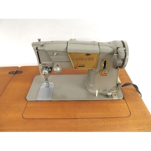 70 - A Singer 221 Featherweight sewing machine serial number EG642200 (lacking case, leads etc) and a Sin... 