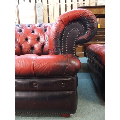 75 - A 20th century red leather button back upholstered Chesterfield style club armchair, 69cm high x 114... 