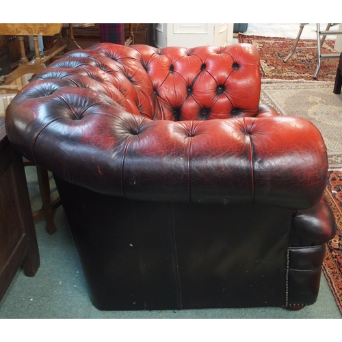 75 - A 20th century red leather button back upholstered Chesterfield style club armchair, 69cm high x 114... 