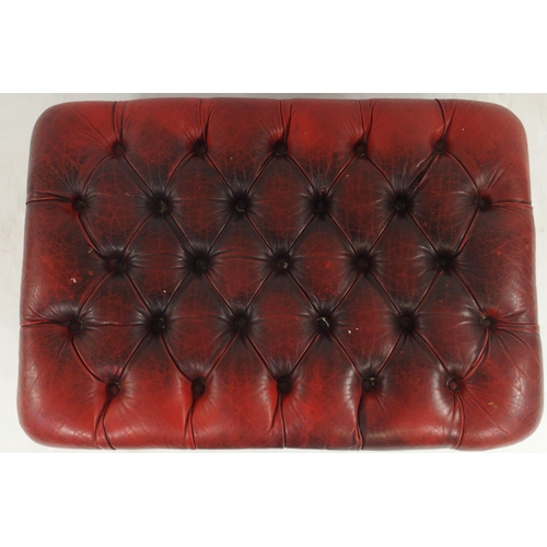 76 - A 20th century red leather button upholstered Chesterfield style ottoman footstool, 41cm high x 90cm... 