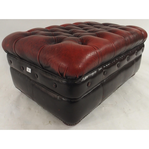 76 - A 20th century red leather button upholstered Chesterfield style ottoman footstool, 41cm high x 90cm... 