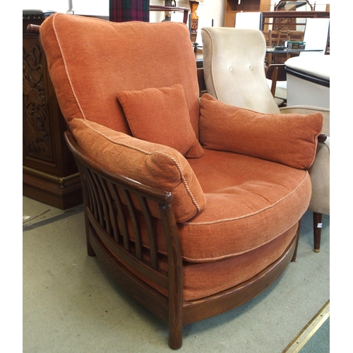 79 - A 20th century elm and beech framed Ercol golden dawn armchair with terracotta upholstery, 96cm high... 