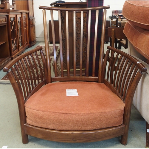 79 - A 20th century elm and beech framed Ercol golden dawn armchair with terracotta upholstery, 96cm high... 