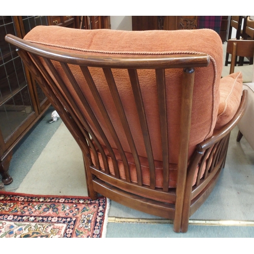 79 - A 20th century elm and beech framed Ercol golden dawn armchair with terracotta upholstery, 96cm high... 