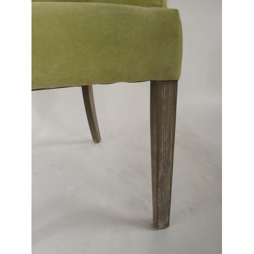 98 - A contemporary lime green upholstered button back armchair, 96cm high x 62cm wide x 66cm deep