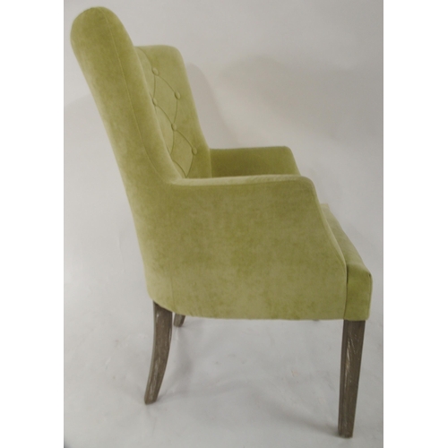 98 - A contemporary lime green upholstered button back armchair, 96cm high x 62cm wide x 66cm deep