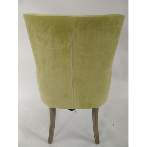 98 - A contemporary lime green upholstered button back armchair, 96cm high x 62cm wide x 66cm deep