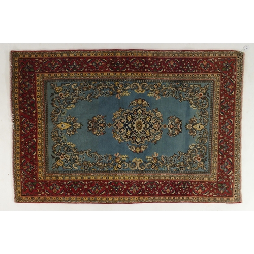 77 - A light blue ground Qom rug with dark blue floral medallion, matching spandrels and red flower head ... 