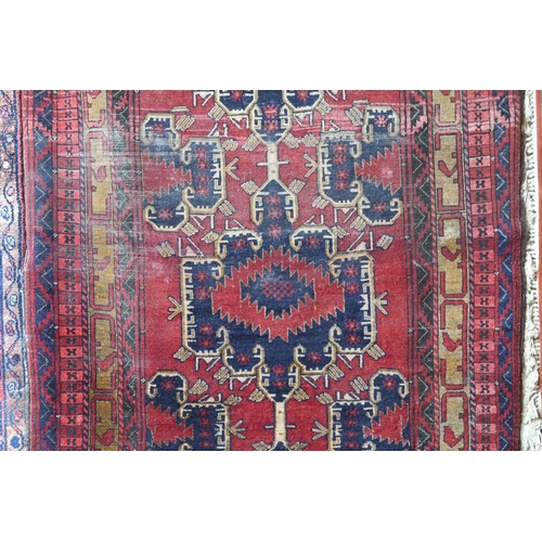 93 - A RED GROUND CAUCASIAN KAZAK RUGwith three geometric medallions and geometric multicoloured border, ... 