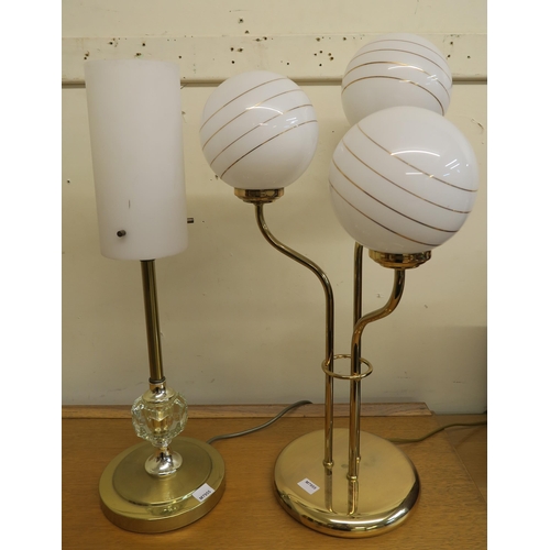 21 - A lot of two 20th century brass based table lamps and an oak cased Singer sewing machine (3)...