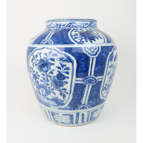 2354 - A CHINESE 'KRAAK' PORCELAIN BROAD JAR Painted with panels of flowers within a key pattern ground, di... 