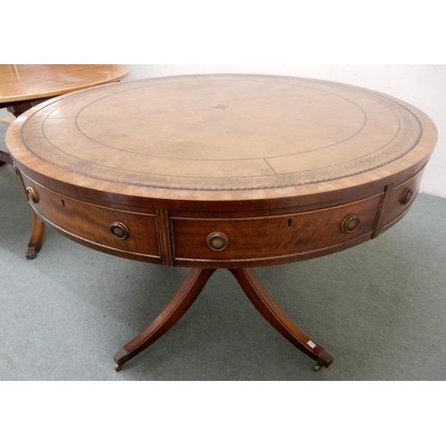 104 - A 20th century mahogany drum table with leather skiver top over four drawers on quadrupedal base, 75... 