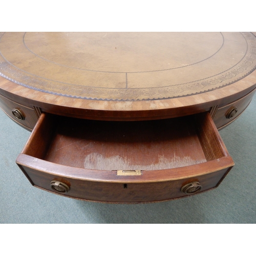 104 - A 20th century mahogany drum table with leather skiver top over four drawers on quadrupedal base, 75... 