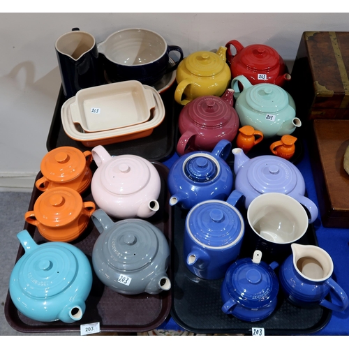 203 - A collection of Le Creuset ceramic items including teapots, jugs, casserole dishes etc