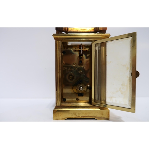 233 - A Mappin and Webb brass and glass carriage clock, with key