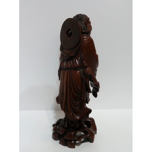 241 - A carved wooden Chinese figure of a man holding a fish