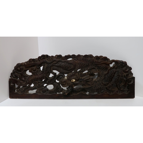 242 - A pair of carved wooden dragon panels