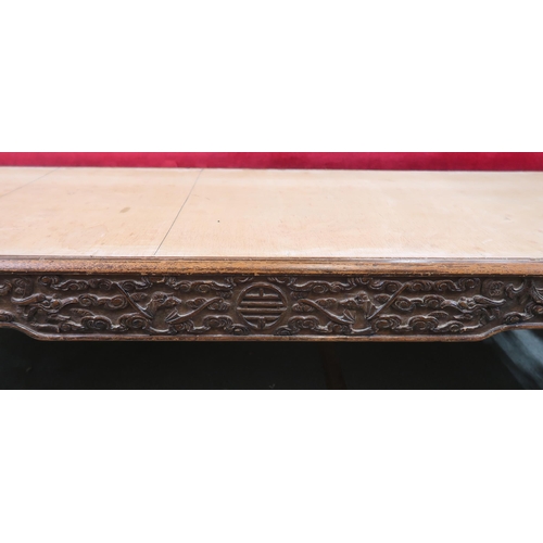 46 - A 19th century Oriental hardwood low coffee table with extensively carved fretwork friezes on shaped... 