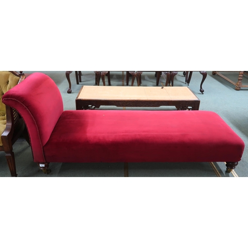 47 - A Victorian red velour upholstered day bed/chaise lounge on turned walnut supports terminating in br...