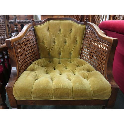 48 - An early 20th century mahogany framed bergere backed armchair and another 20th century bergere butto...