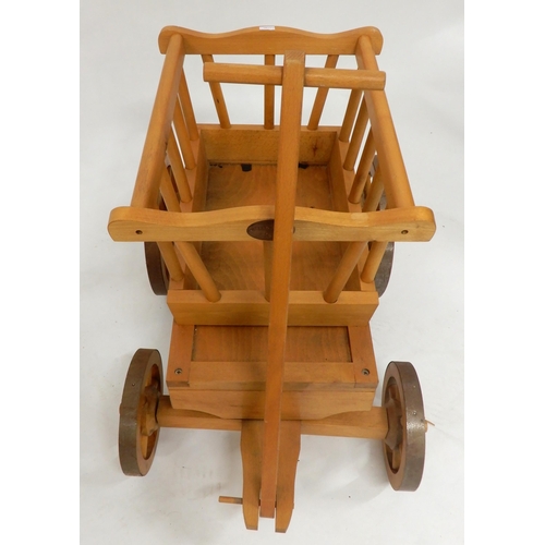 69 - A contemporary Moulin Roty child's pull cart and a contemporary child's rocking chair with carved an... 