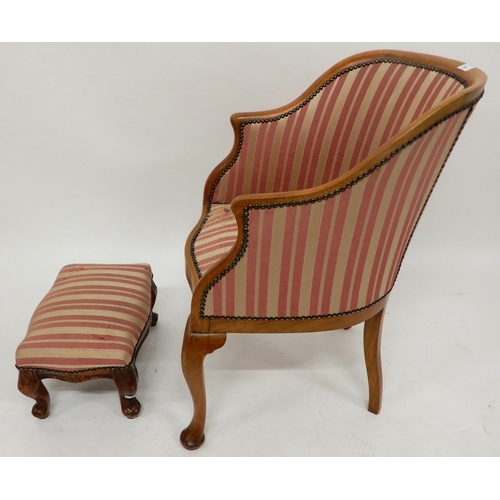 91 - A 20th century mahogany framed tub chair on cabriole supports and accompanying footstool both uphols... 