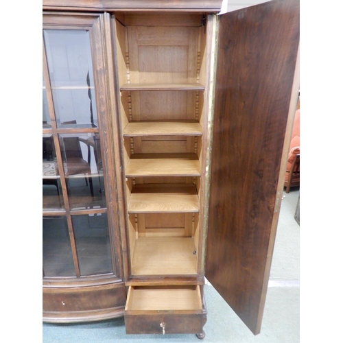 96 - An early 20th century mahogany bookcase with central bowed glazed door flanked by walnut veneered ca... 