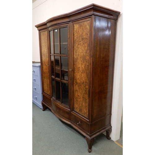 96 - An early 20th century mahogany bookcase with central bowed glazed door flanked by walnut veneered ca... 