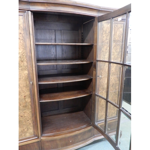 96 - An early 20th century mahogany bookcase with central bowed glazed door flanked by walnut veneered ca... 