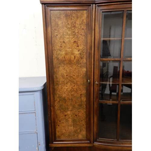 96 - An early 20th century mahogany bookcase with central bowed glazed door flanked by walnut veneered ca... 