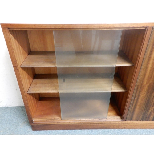 98 - A mid 20th century Afromosia teak bookcase with pair of glazed sliding doors alongside pair of cabin... 