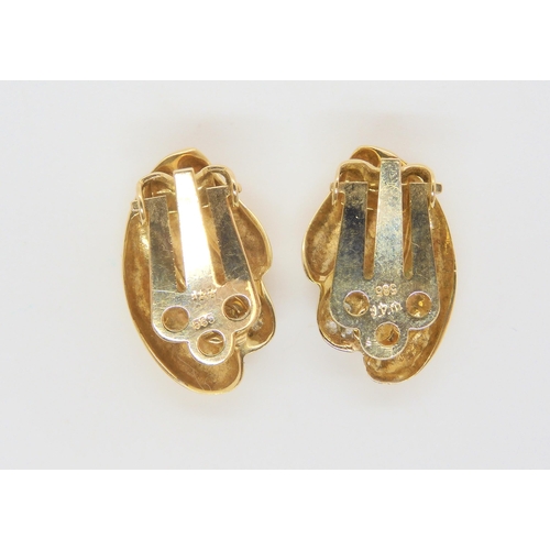 642 - A pair of 14k gold clip on earrings with cz accents, weight 5.9gms...