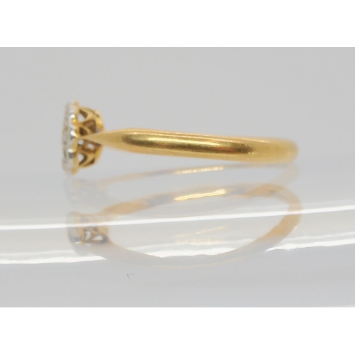 688 - An 18ct gold old cut diamond flower ring, set with estimated approx 0.10cts of old cut diamonds, fin... 