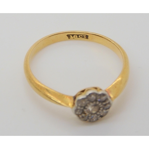 688 - An 18ct gold old cut diamond flower ring, set with estimated approx 0.10cts of old cut diamonds, fin... 