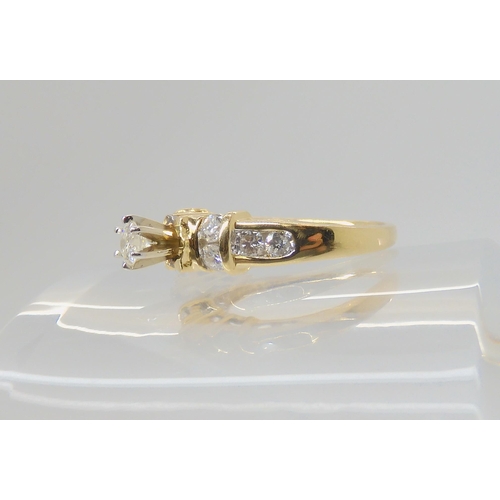 692 - A 14k gold diamond ring, the central high prong set diamond is estimated approximately at 0.20cts wi... 