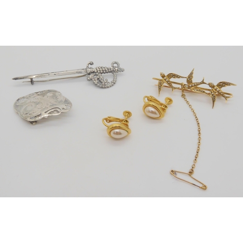 702 - A yellow metal pearl set three swallows brooch, weight 6gms, two silver brooches, the sword shaped o... 