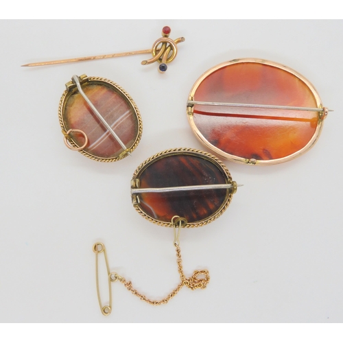 703 - Three yellow metal mounted agate specimen brooches, together with a 9ct gold red and blue gem set pi... 