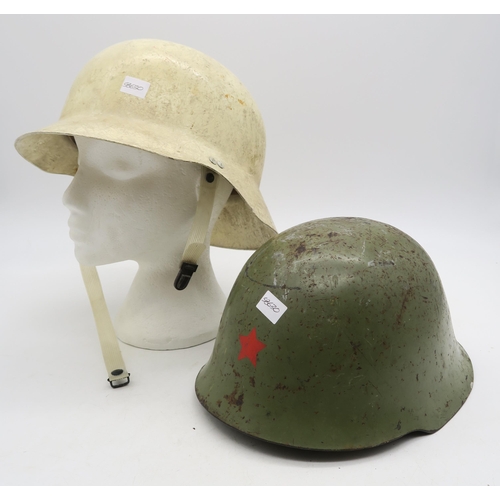 402 - A Yugoslavian M59 steel helmet and a West German fibreglass Civil Defence helmet (2)