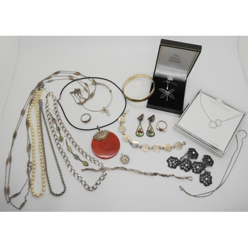 731 - A collection of silver and costume jewellery to include silver bangles, chains and a boxed dragonfly... 