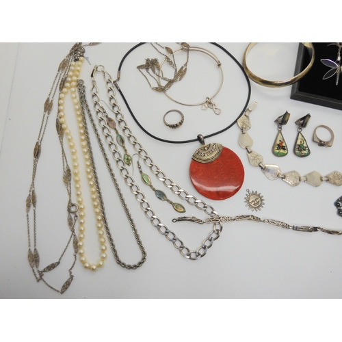 731 - A collection of silver and costume jewellery to include silver bangles, chains and a boxed dragonfly... 