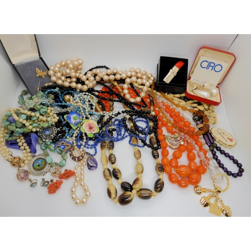 750 - Two antler horn bead necklaces, a perfume bottle key ring, a boxed Monet butterfly pin and other ite... 