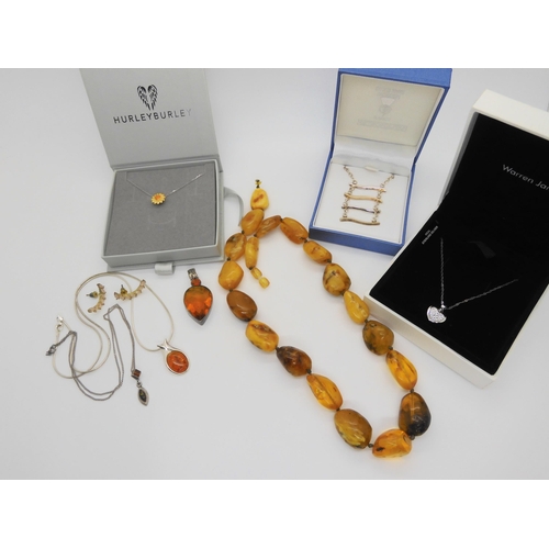 760 - A string of amber coloured beads, further silver items set with amber, A designer silver 'Spinner' p... 