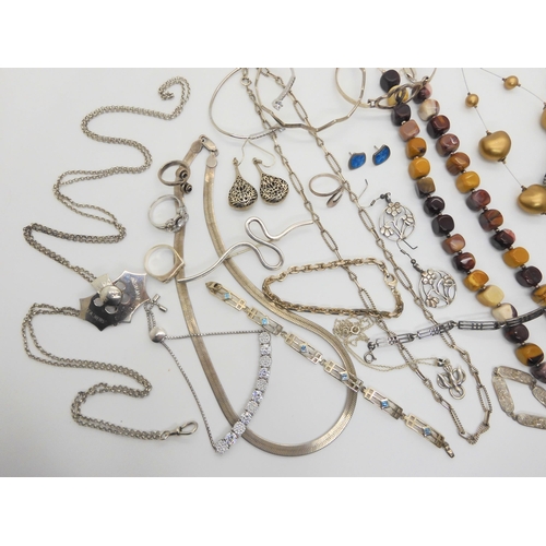 764 - A collection of silver and costume jewellery to include, heavy silver decorative chains, bangles, br... 